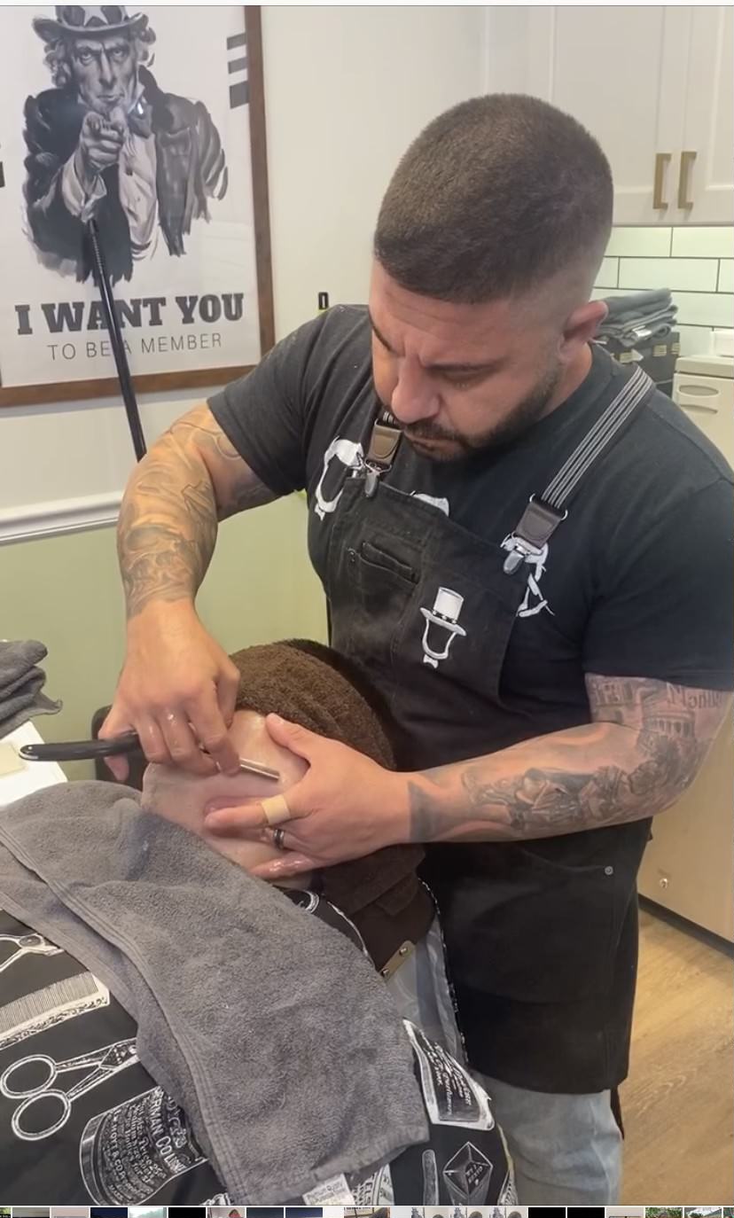 Saverio performing precision shave work on a customer